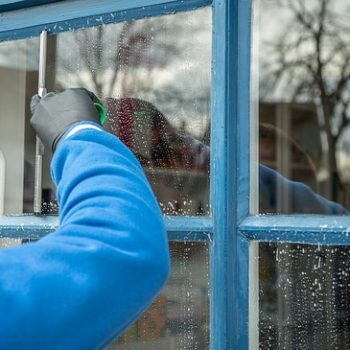 man cleaning window