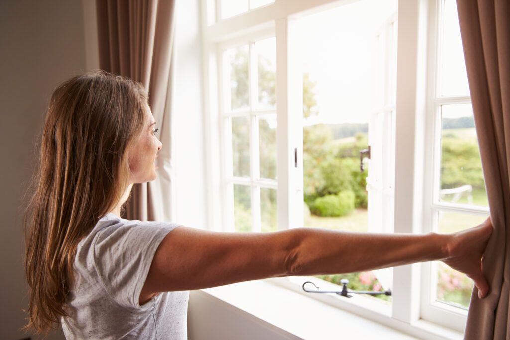 woman opening her window