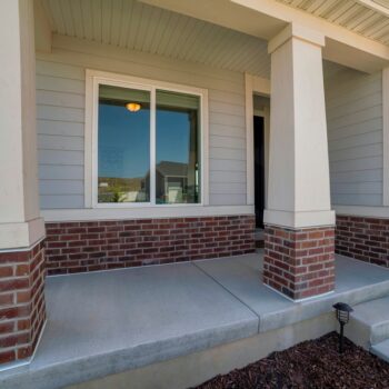 A closeup of a sliding window on a front porch