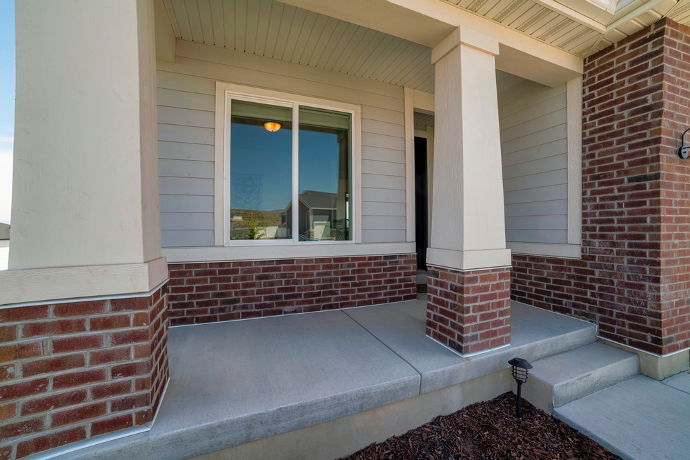 A closeup of a sliding window on a front porch